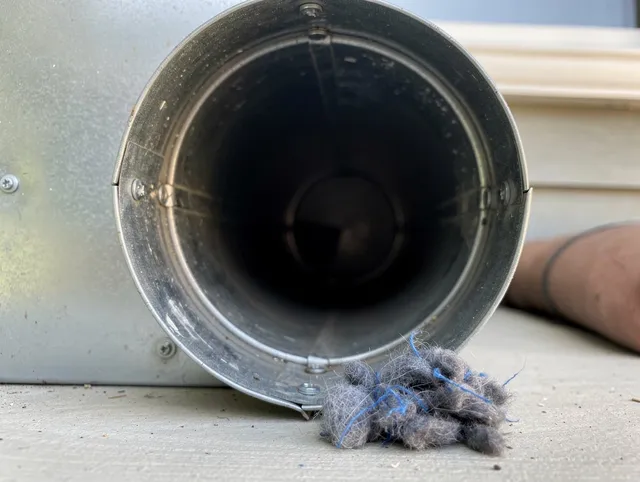 Norwich Dryer Vent Cleaning technician using specialized equipment to clear severe dryer vent blockage in Norwich